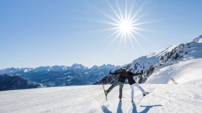 Fun on the slopes in Latemar in South Tyrol under a bright blue sky.© Harald Wisthaler