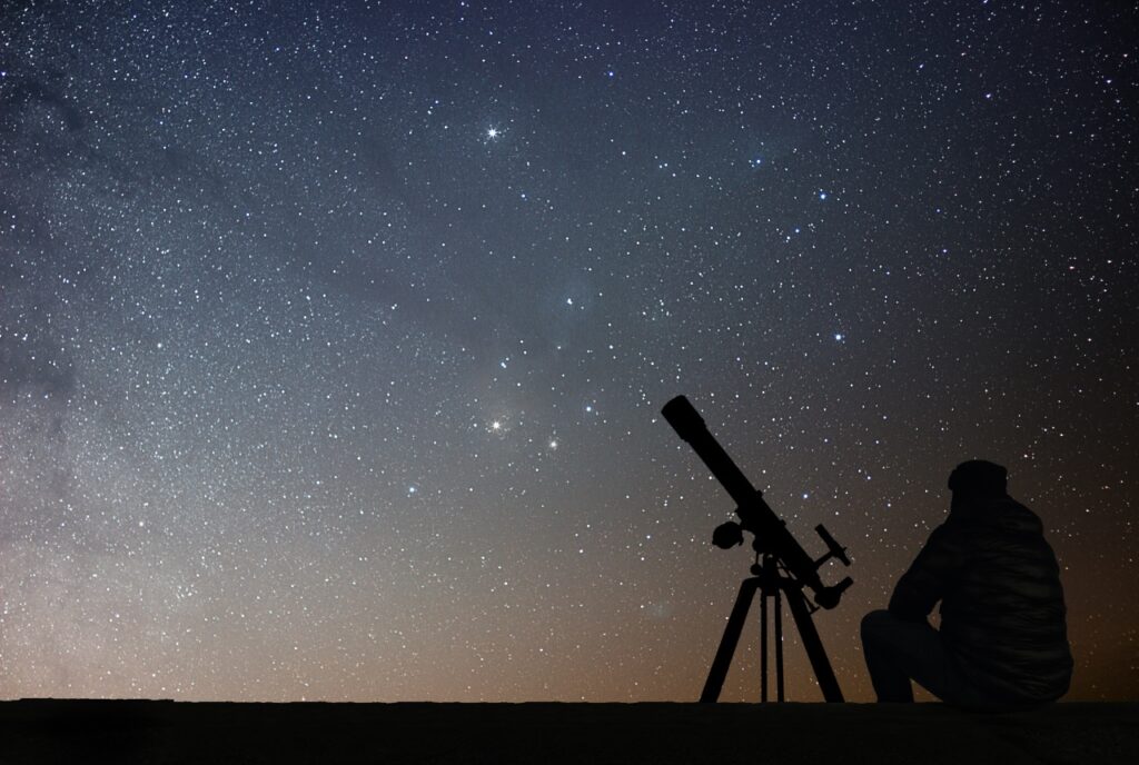 Fernrohr vor dem nächtlichen Sternenhimmel